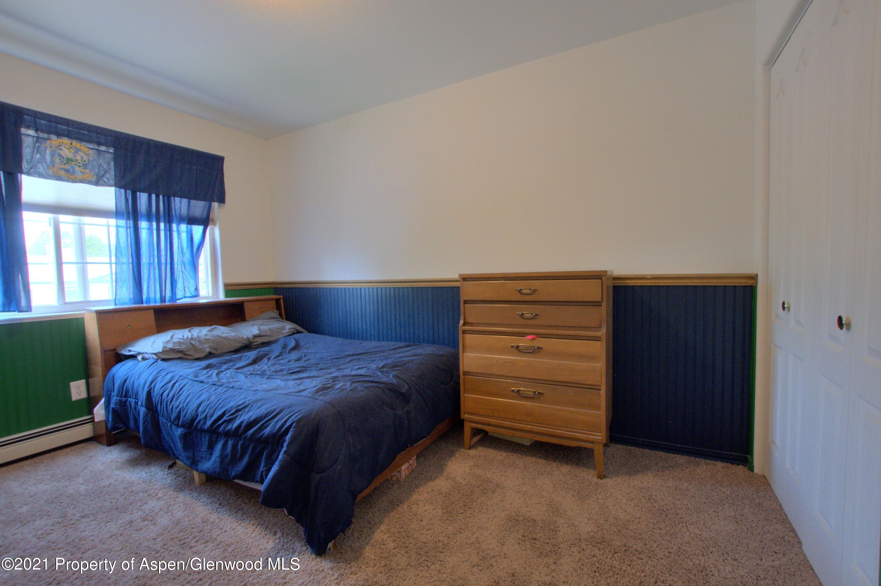 1554 East 12th Street Rifle, CO 81650 - Photo 19 of 31 a bedroom with a bed and a dresser