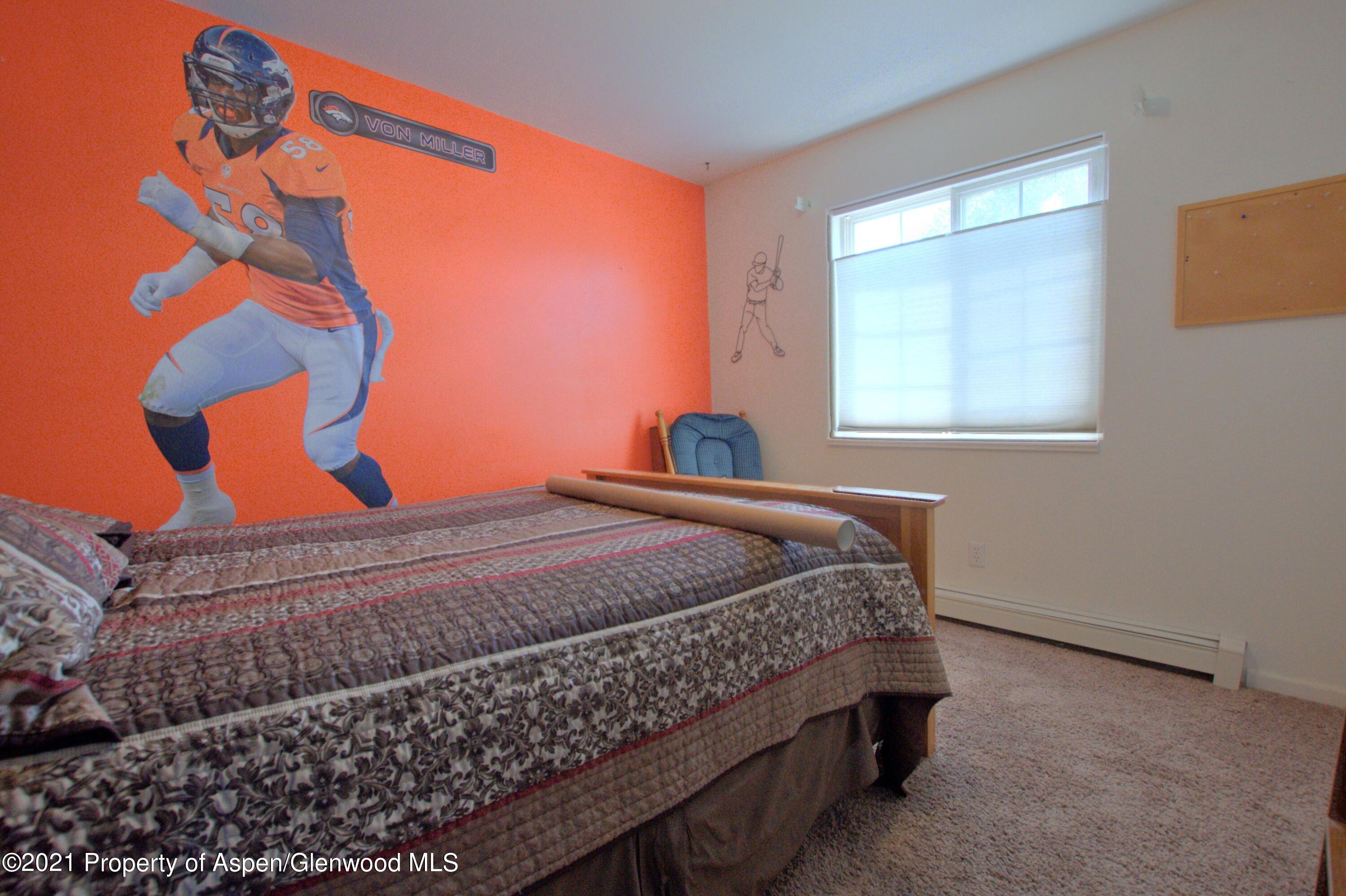 1554 East 12th Street Rifle, CO 81650 - Photo 20 of 31 a bedroom with a bed and a window