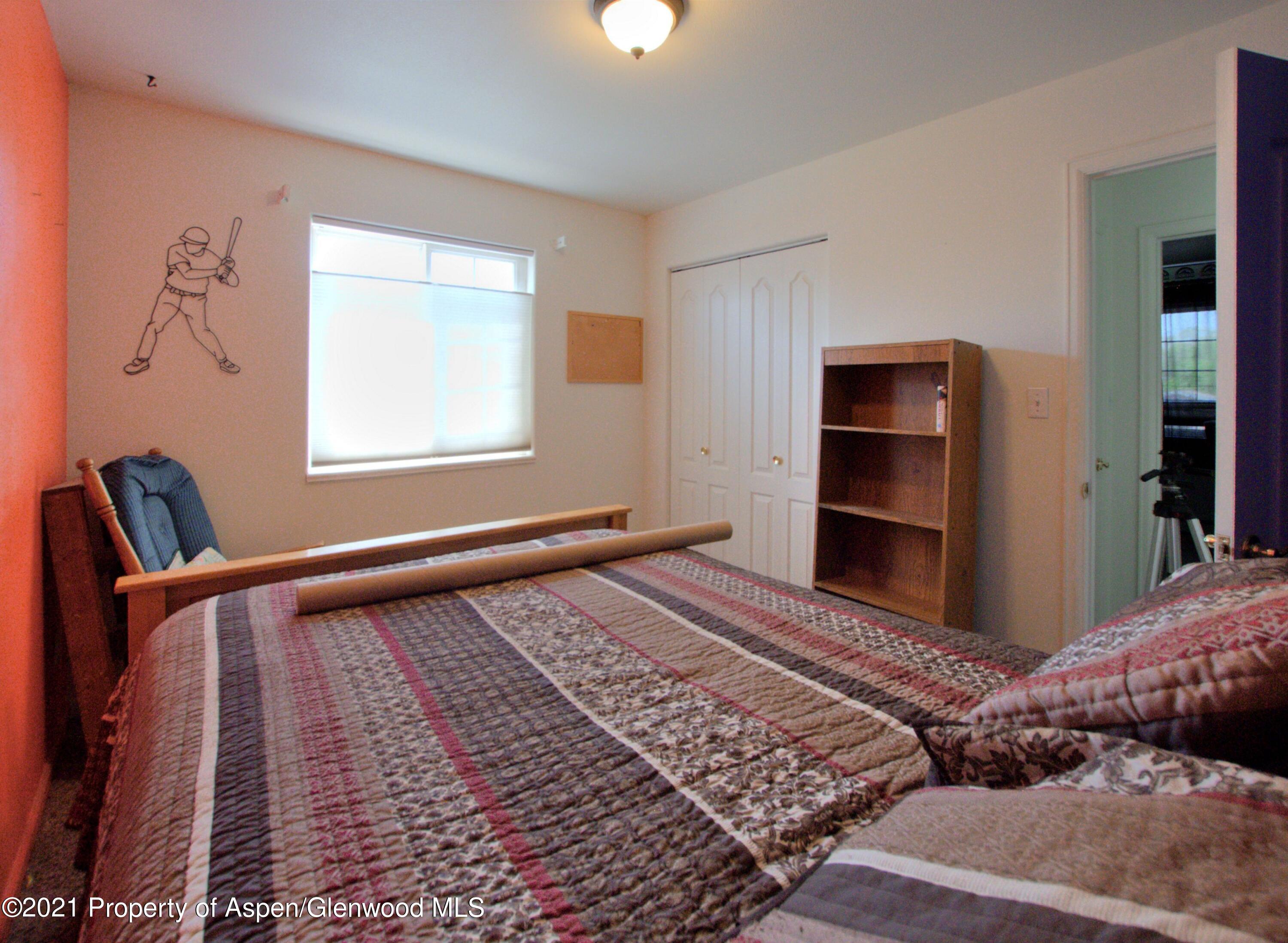 1554 East 12th Street Rifle, CO 81650 - Photo 21 of 31 a bedroom with a bed and a window