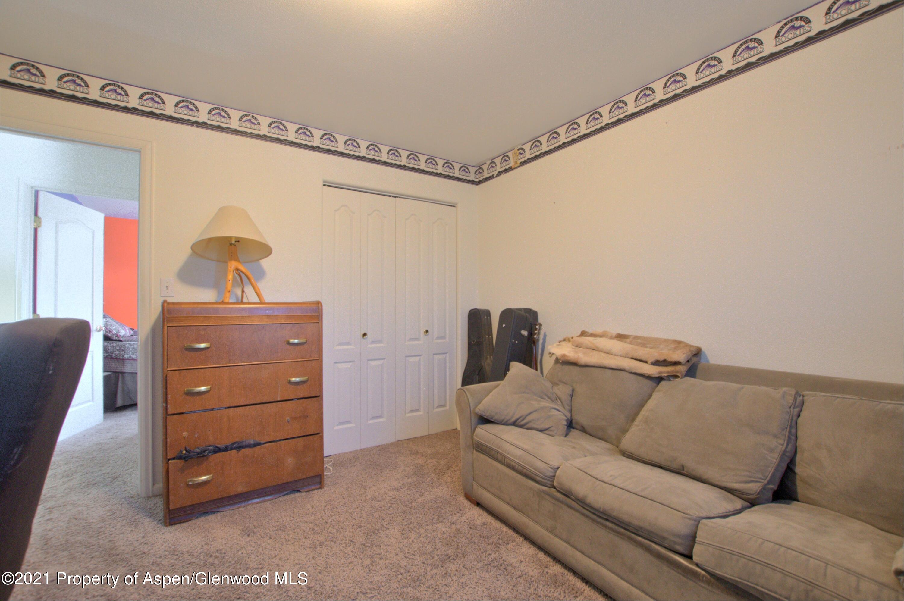 1554 East 12th Street Rifle, CO 81650 - Photo 23 of 31 a living room with furniture and a dresser
