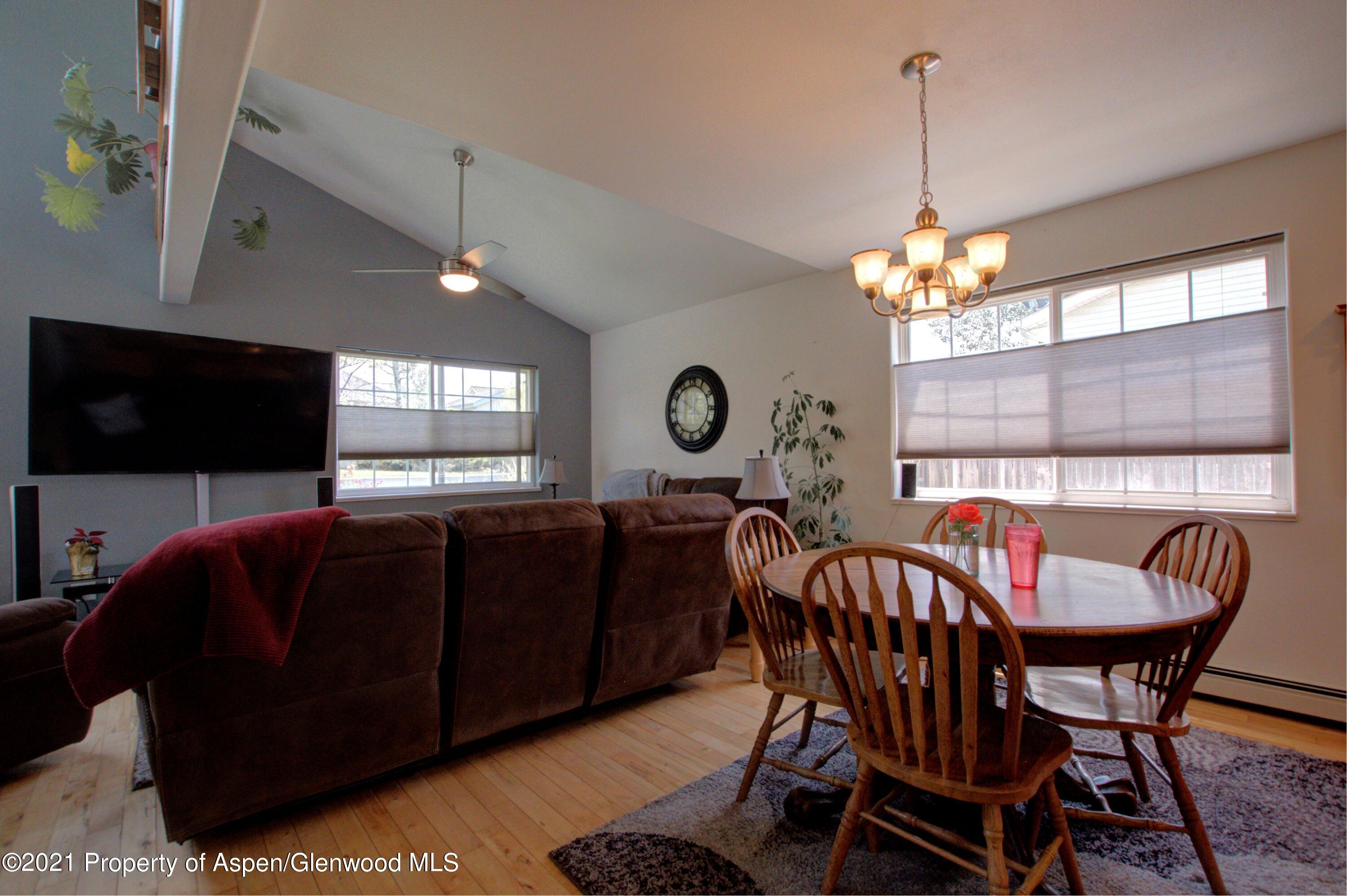 1554 East 12th Street Rifle, CO 81650 - Photo 6 of 31 a dining room with furniture a chandelier and window