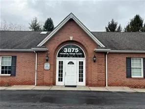 a view of a brick house with large windows