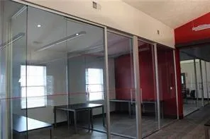 a room with table chairs and window