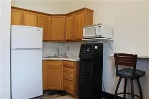 a kitchen with a refrigerator and a stove