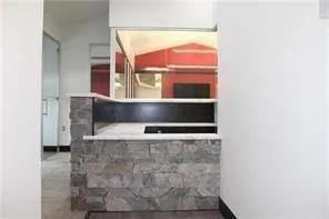 a living room with a bench and a window