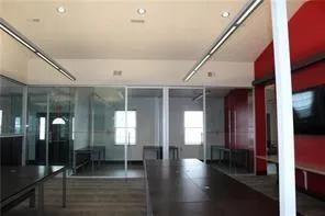 a view of a hallway with an entryway and wooden floor