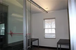 a bathroom with a window and a shower