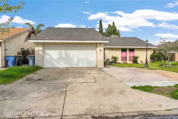 a front view of a house with a yard and a garage