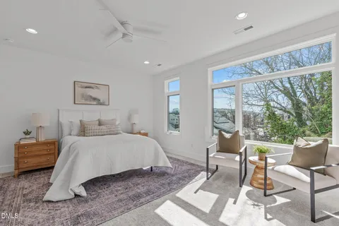 a bedroom with a large bed and a window
