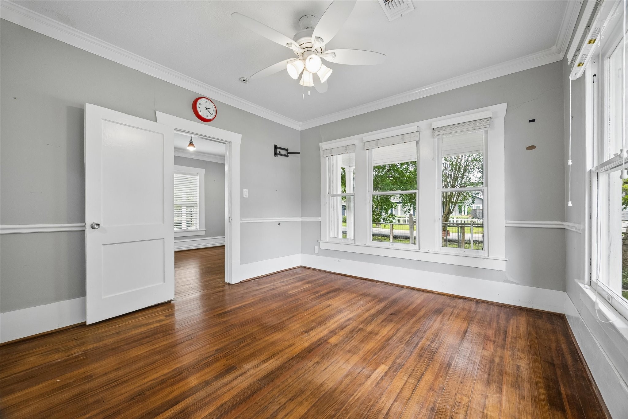 1201 Tulane Street Houston, TX 77008 - Photo 22 of 31 One of two bedrooms, this roomy space offers the perfect place to begin and end your day. Warm hardwood floors, oversized windows, fresh neutral finishes, and timeless Craftsman details create a comfortable bedroom that feels calm, charming, and easy to make your own.