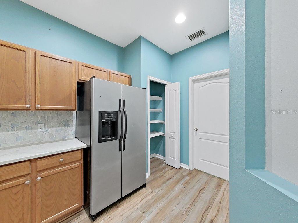 6077 Sandhill Ridge Drive Lithia, FL 33547 - Photo 11 of 58 a kitchen with stainless steel appliances a refrigerator and cabinets