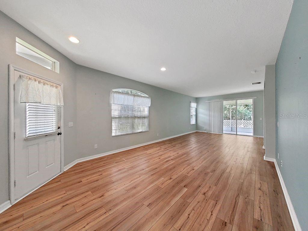 6077 Sandhill Ridge Drive Lithia, FL 33547 - Photo 17 of 58 a view of empty room with wooden floor and fan