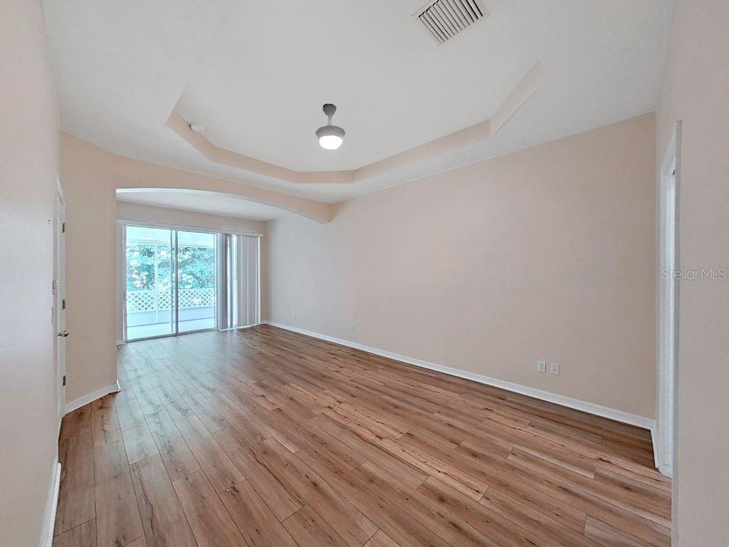 6077 Sandhill Ridge Drive Lithia, FL 33547 - Photo 23 of 58 a view of an empty room with wooden floor and a window