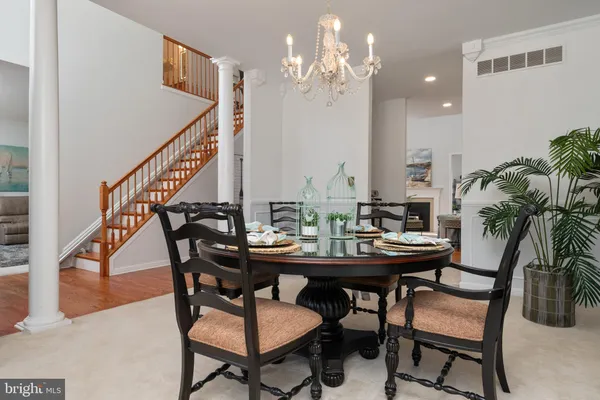 a view of a dining room with furniture and a chandelier