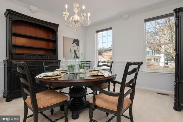 a view of a dining room with furniture and chandelier