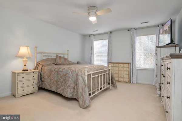 a bedroom with a bed dresser and a window