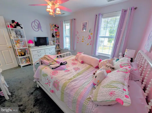 a bedroom with a bed dresser and a window