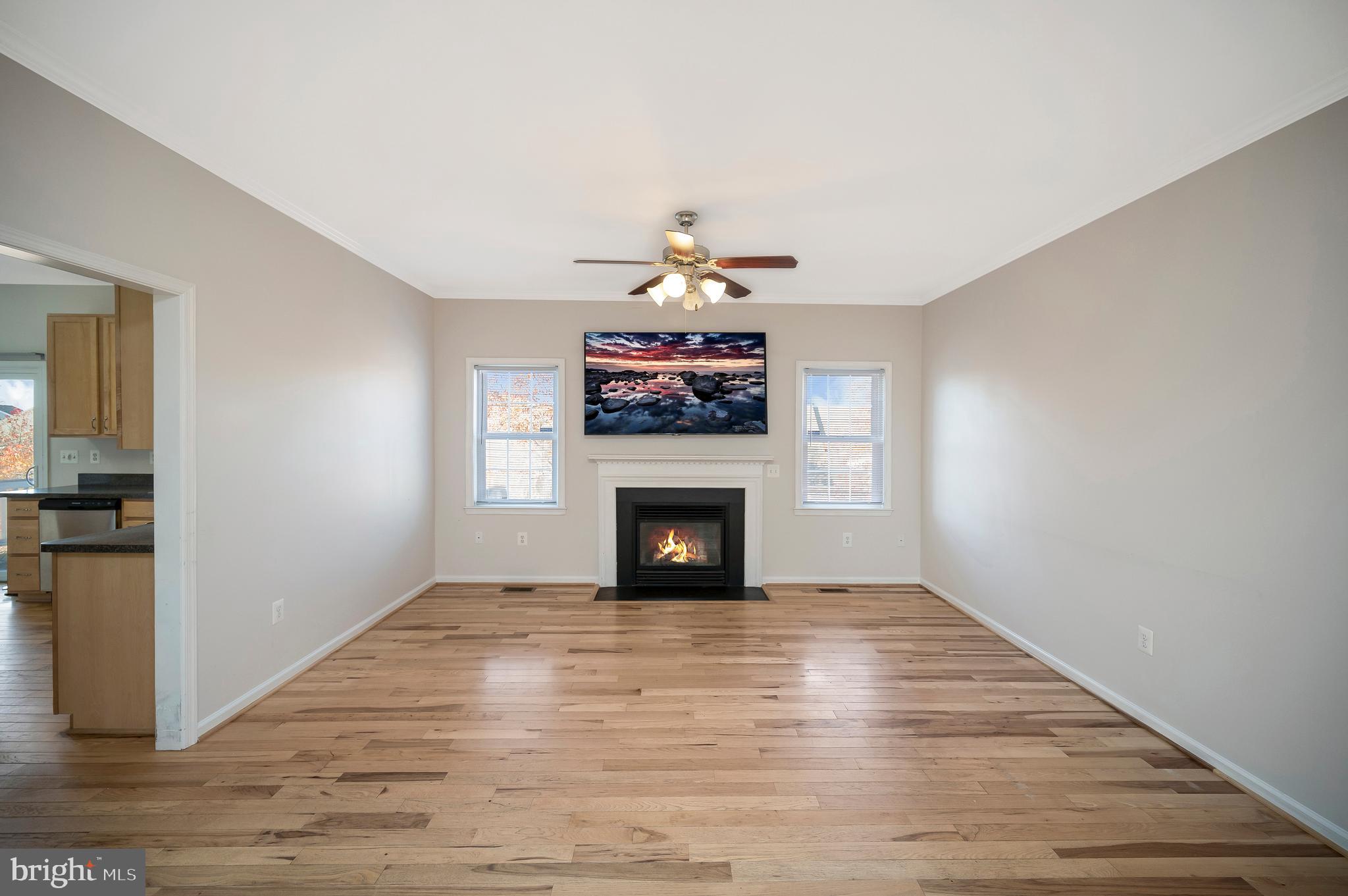 773 Truslow Road Fredericksburg, VA 22406 - Photo 19 of 63 a view of an empty room with wooden floor fireplace and a window