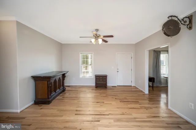 a dining room with furniture a chandelier and wooden floor