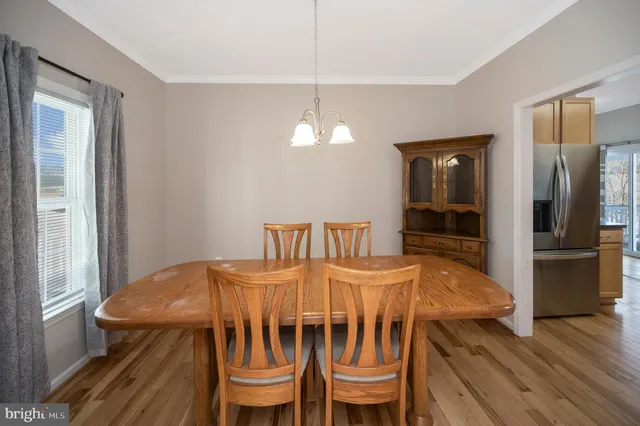 a large kitchen with granite countertop a large counter top stainless steel appliances and cabinets