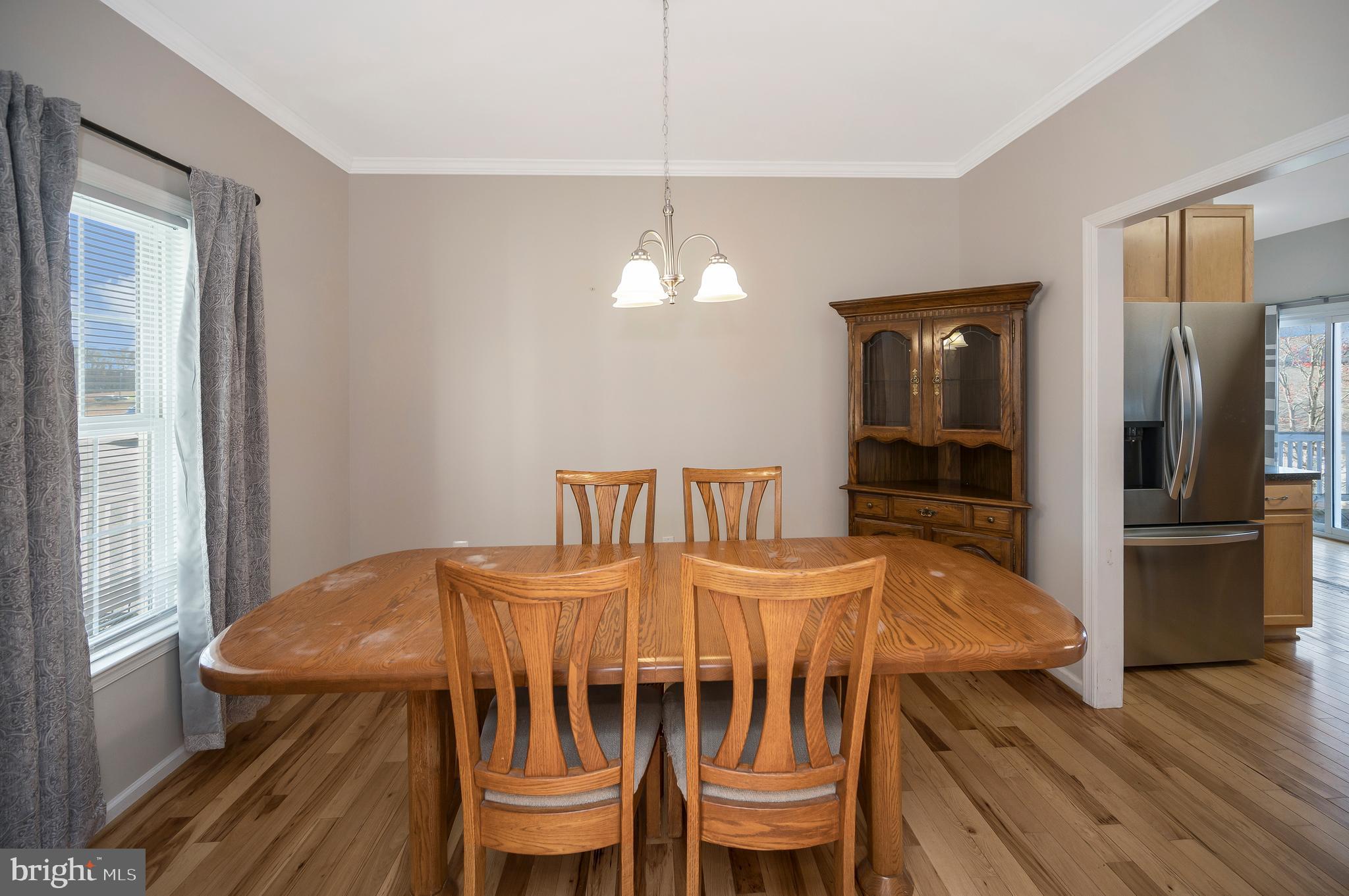 773 Truslow Road Fredericksburg, VA 22406 - Photo 22 of 63 a dining room with furniture a chandelier and wooden floor