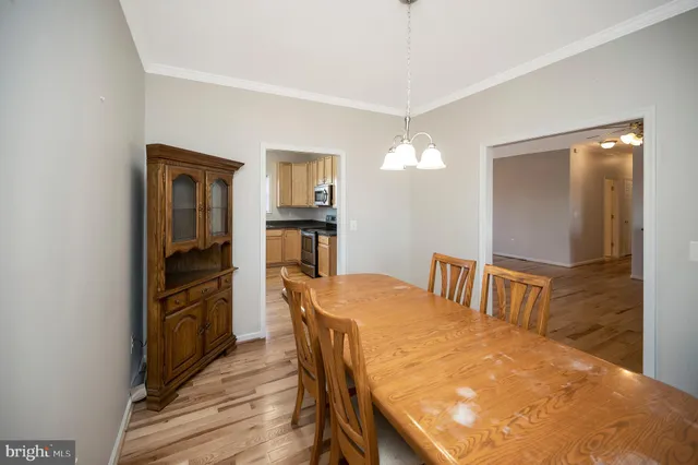a kitchen with granite countertop white cabinets and sink