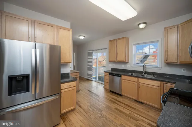 a kitchen with granite countertop a stove and a sink