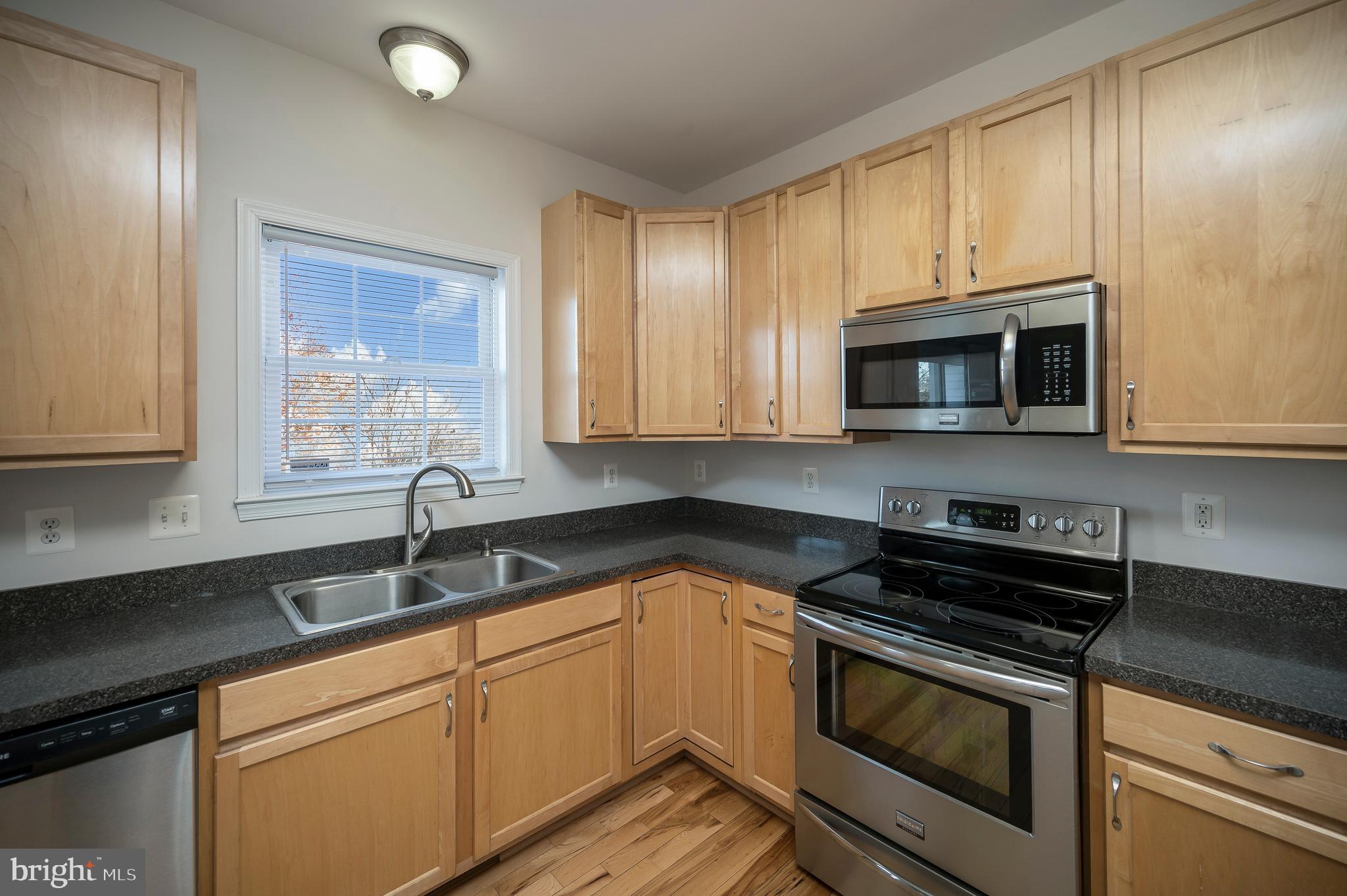773 Truslow Road Fredericksburg, VA 22406 - Photo 27 of 63 a kitchen with granite countertop white cabinets stainless steel appliances and a sink
