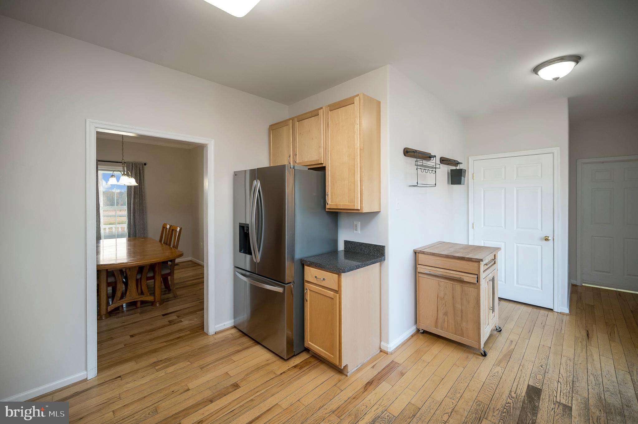773 Truslow Road Fredericksburg, VA 22406 - Photo 29 of 63 a kitchen with stainless steel appliances a refrigerator and wooden floor
