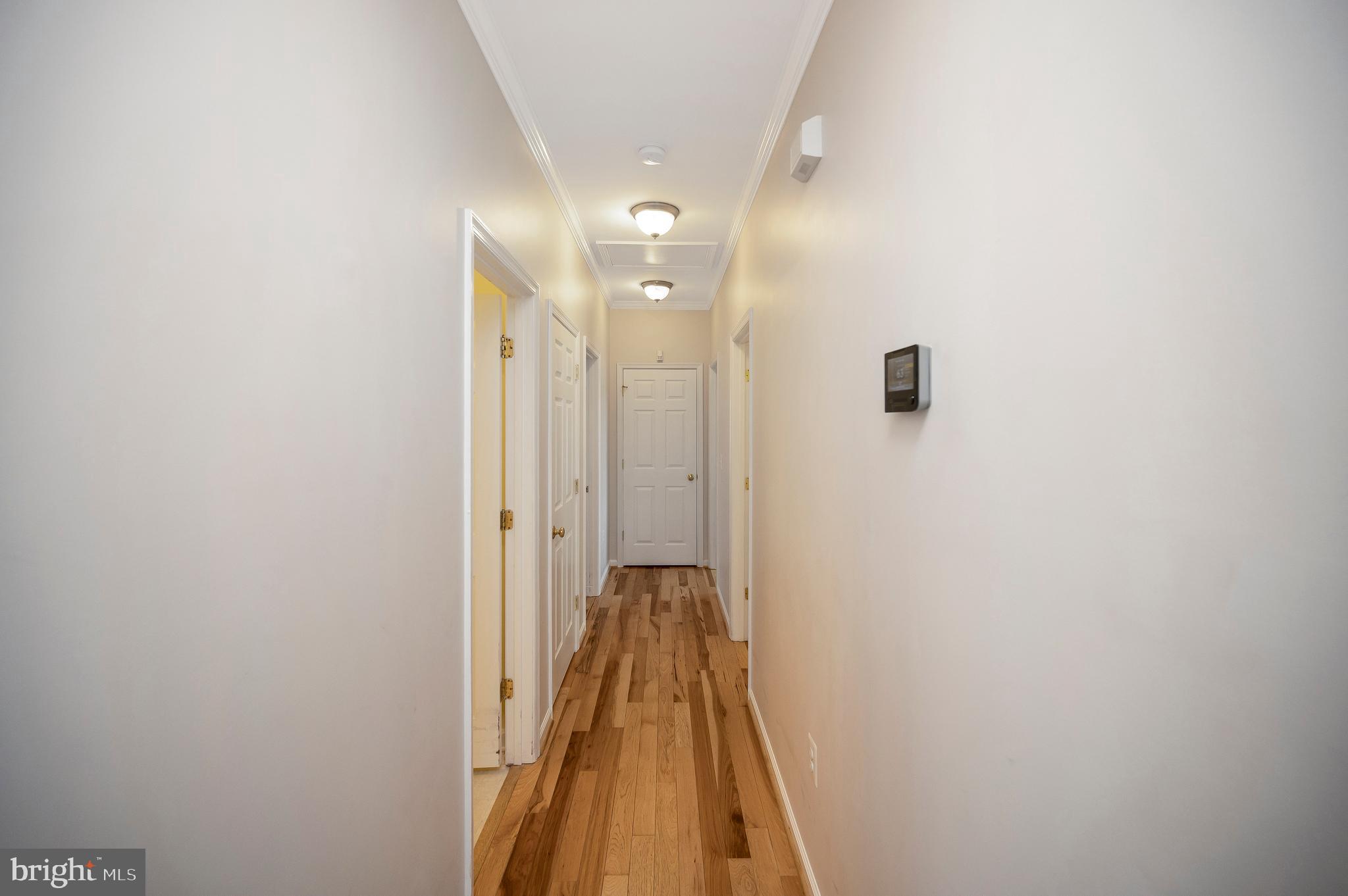 773 Truslow Road Fredericksburg, VA 22406 - Photo 35 of 63 a view of a hallway with wooden floor and a bathroom