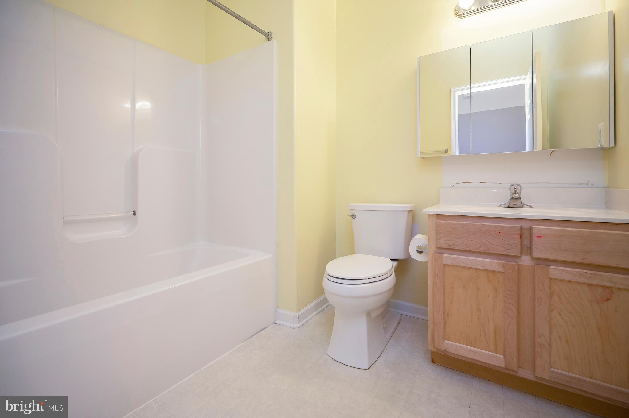 773 Truslow Road Fredericksburg, VA 22406 - Photo 36 of 63 a bathroom with a toilet a sink a mirror and bathtub