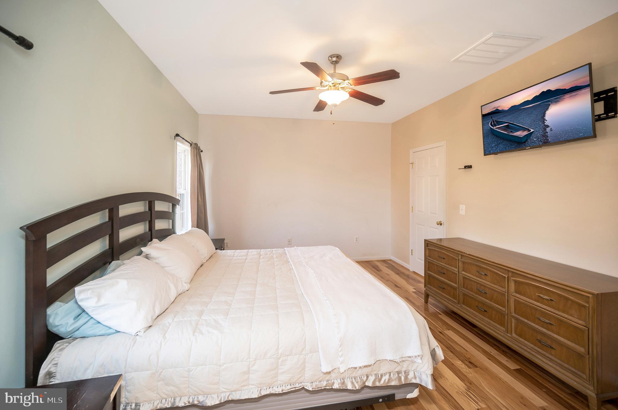 773 Truslow Road Fredericksburg, VA 22406 - Photo 42 of 63 a bedroom with a bed and painting on the wall