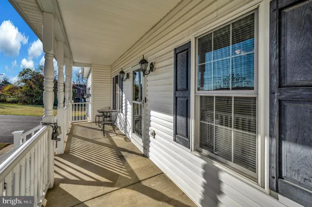 a view of a balcony with a floor to ceiling window and wooden floor