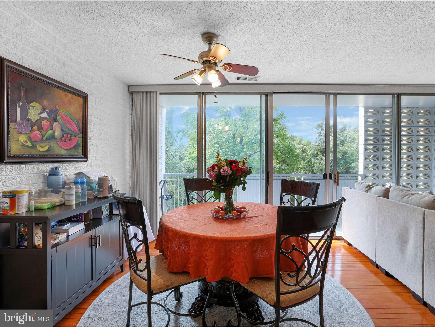 a dining room with furniture a chandelier and wooden floor