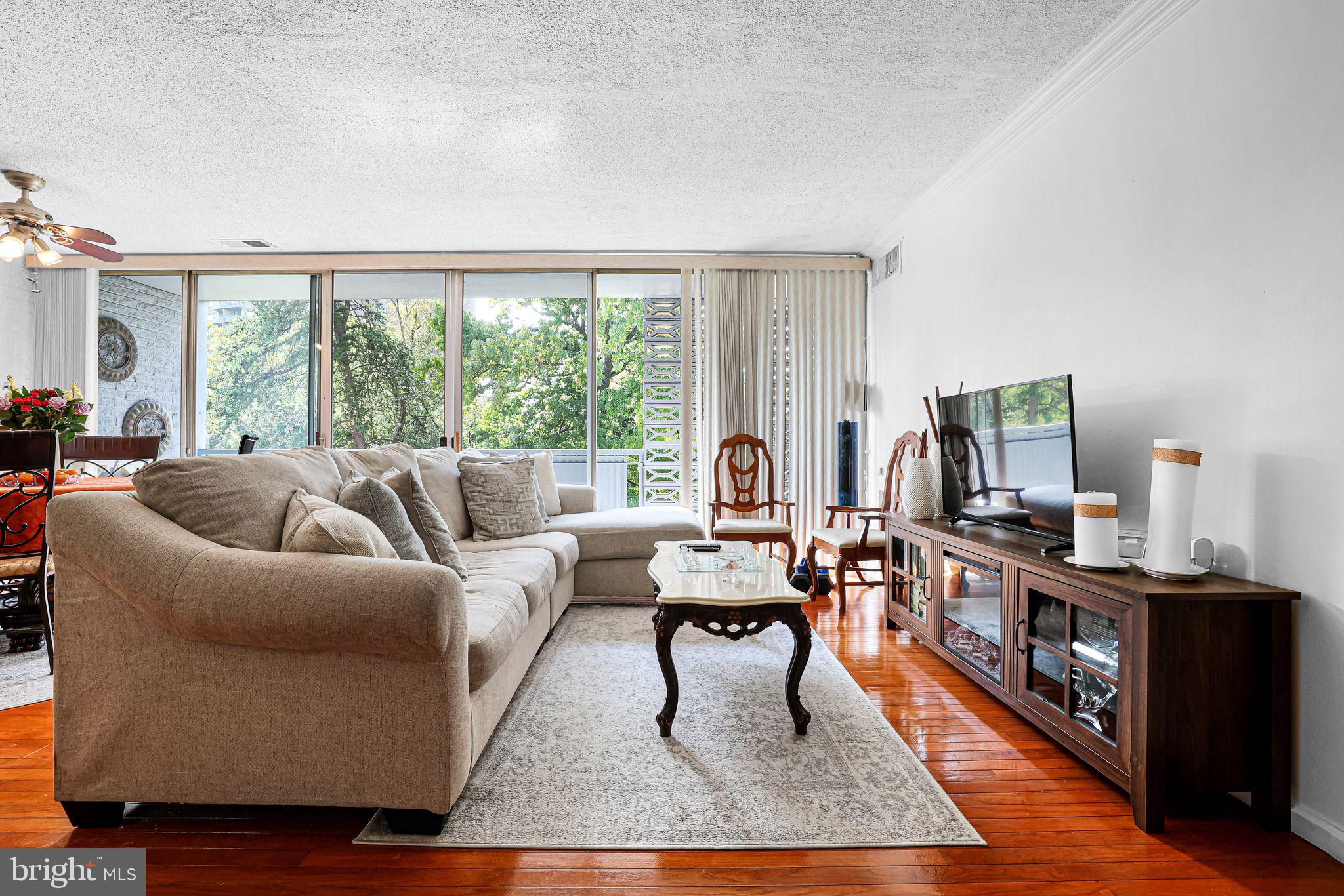 1828 Metzerott Road, Unit 202 Hyattsville, MD 20783 - Photo 11 of 18 a living room with furniture and a flat screen tv