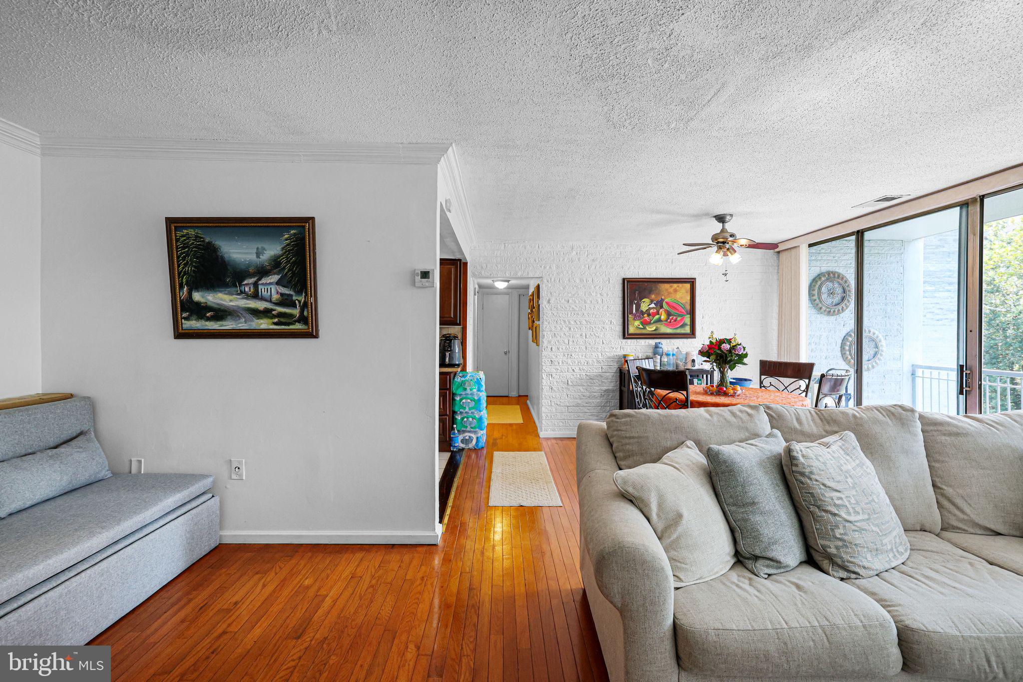 1828 Metzerott Road, Unit 202 Hyattsville, MD 20783 - Photo 13 of 18 a living room with furniture and a wooden floor