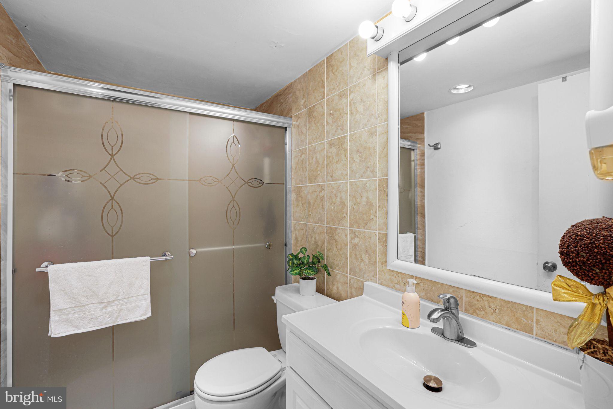 1828 Metzerott Road, Unit 202 Hyattsville, MD 20783 - Photo 14 of 18 a bathroom with a sink toilet and shower