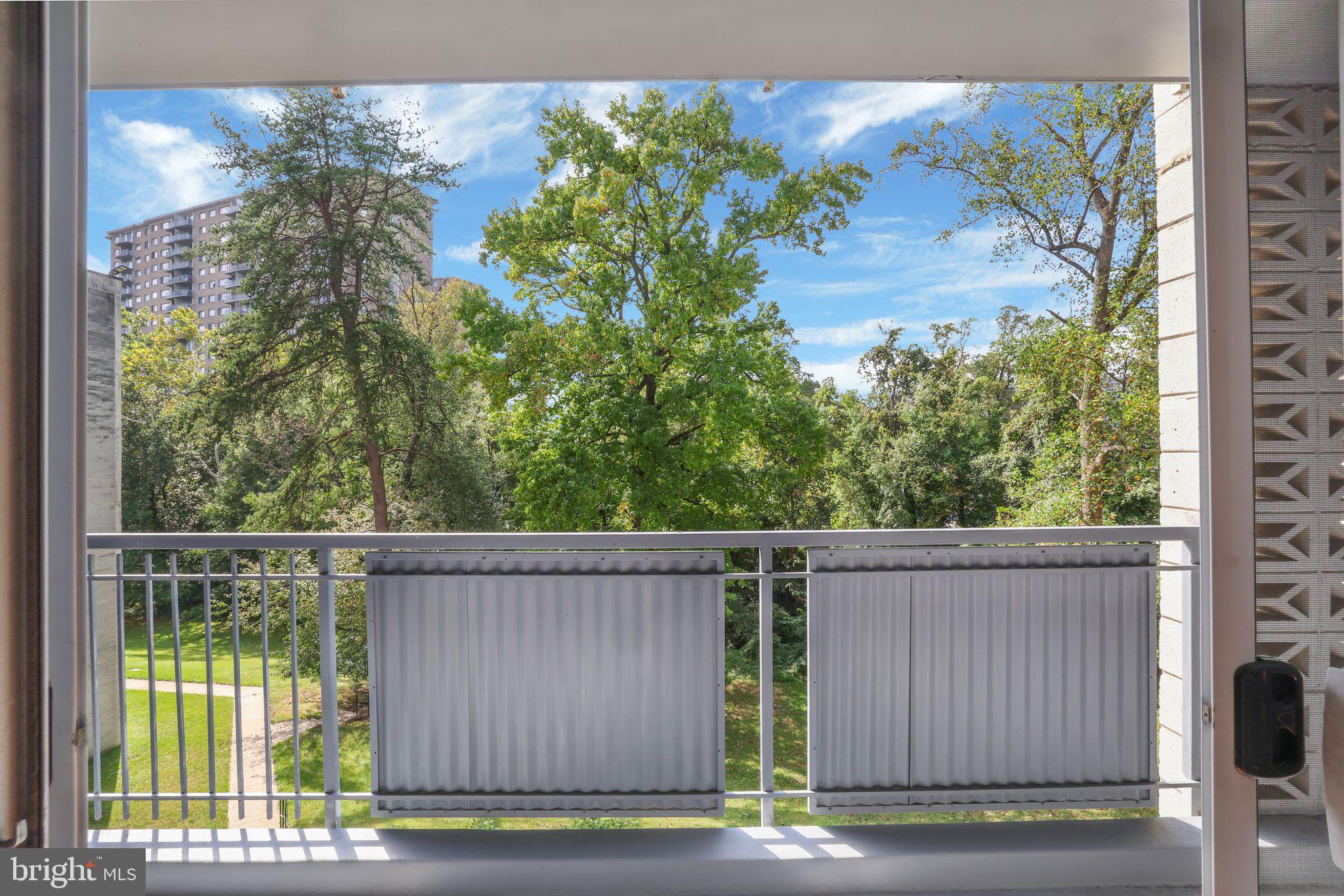 1828 Metzerott Road, Unit 202 Hyattsville, MD 20783 - Photo 15 of 18 a view of a house with a tree in the background