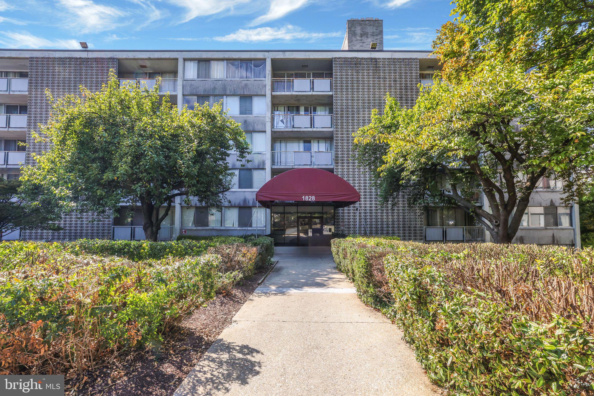 1828 Metzerott Road, Unit 202 Hyattsville, MD 20783 - Photo 18 of 18 a view of a house with a yard and potted plants