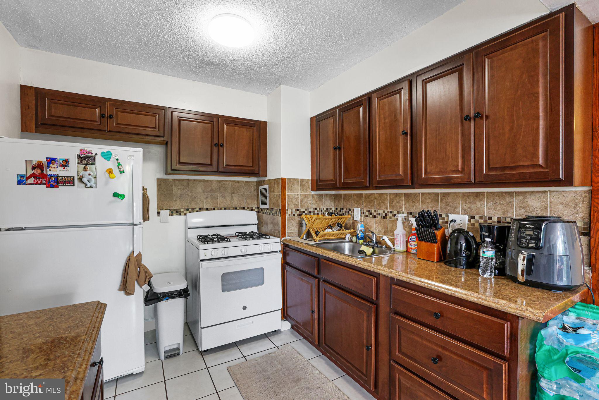 1828 Metzerott Road, Unit 202 Hyattsville, MD 20783 - Photo 8 of 18 a kitchen with stainless steel appliances granite countertop a refrigerator and a stove top oven