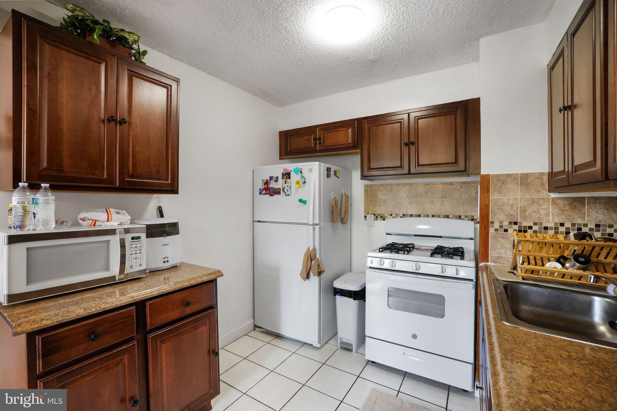 1828 Metzerott Road, Unit 202 Hyattsville, MD 20783 - Photo 9 of 18 a kitchen with a refrigerator stove and sink