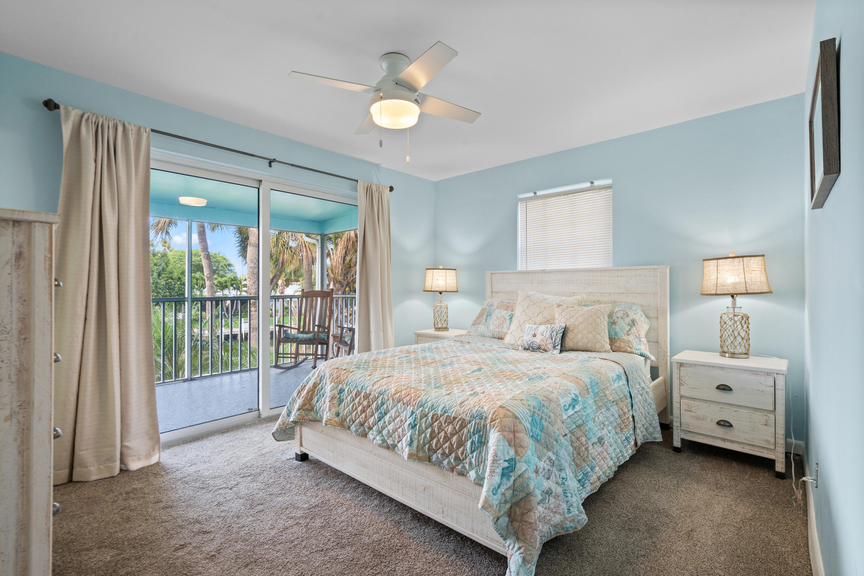 249 Center Street, Unit 2C Jupiter, FL 33458 - Photo 18 of 29 a bedroom with a bed and a large window