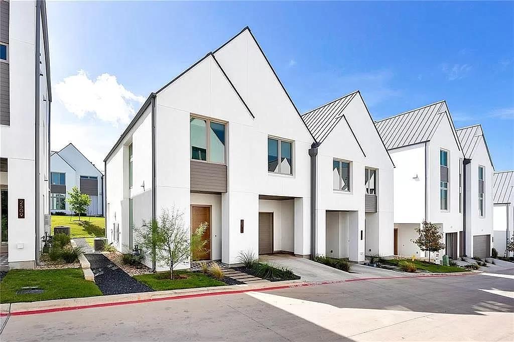 2519 Sutherland Street Austin, TX 78746 - Photo 1 of 14 a view of a white building among the street with palm trees