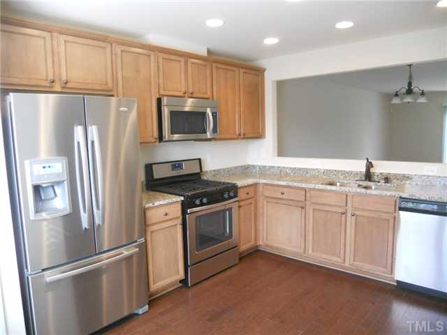 6617 Morgantown Street Raleigh, NC 27616 - Photo 4 of 12 a kitchen with stainless steel appliances granite countertop a refrigerator a stove a sink and a microwave