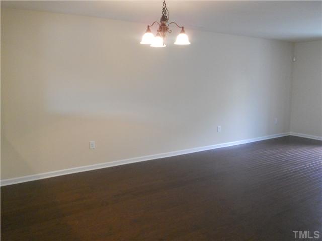 6617 Morgantown Street Raleigh, NC 27616 - Photo 5 of 12 an empty room with wooden floor and windows
