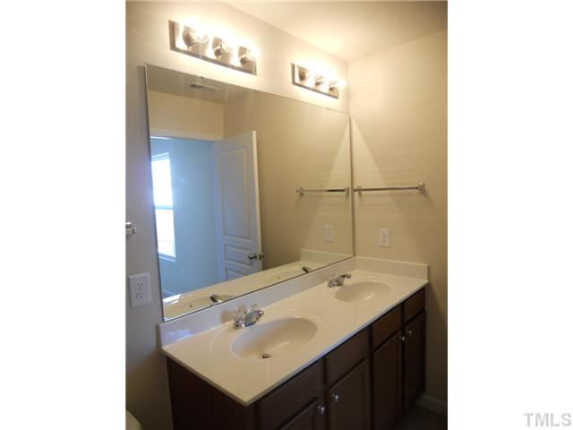 6617 Morgantown Street Raleigh, NC 27616 - Photo 9 of 12 a bathroom with a sink and a mirror