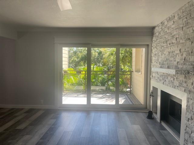 1740 Alderman Street, Unit 7 Sarasota, FL 34236 - Photo 20 of 35 a view of an empty room with wooden floor and a fireplace