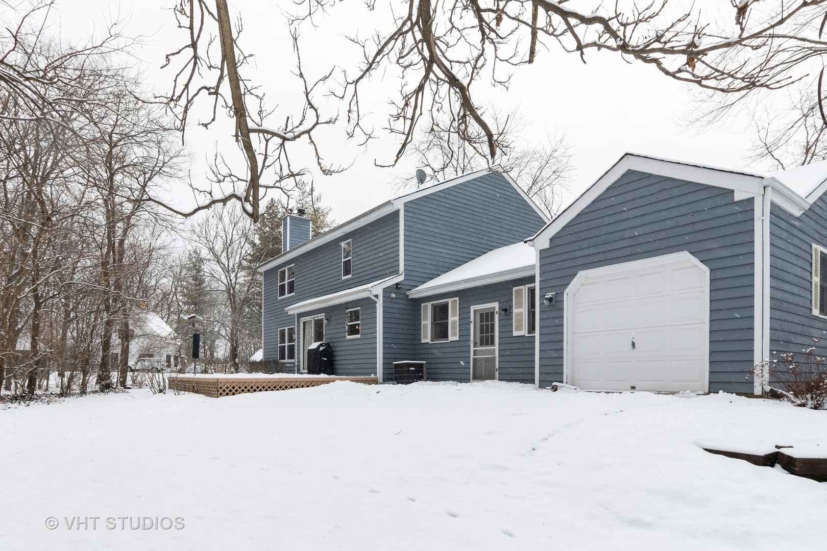 31W740 Russell Road Wayne, IL 60184 - Photo 2 of 20 a view of a white house with a yard covered in snow
