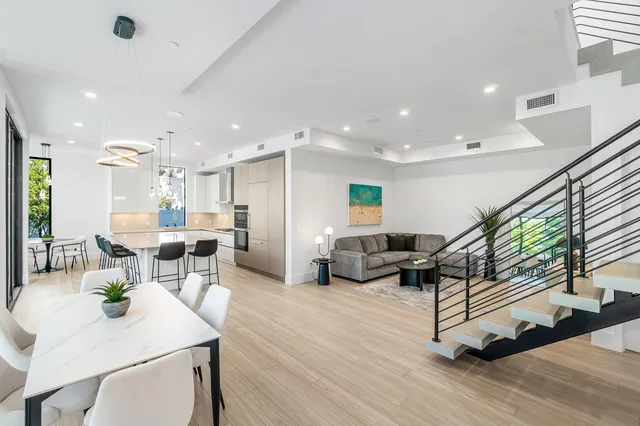 a kitchen with kitchen island a stove a refrigerator and a sink