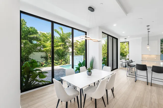 a living room with furniture and a floor to ceiling window